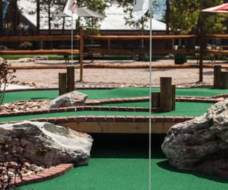 Almost Heaven Mini Golf course with stone borders and mountain views