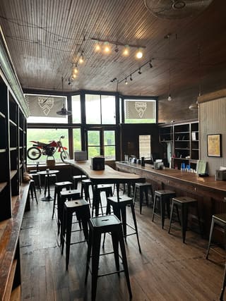 Counter seating and Blackwater 100 motorcycle decor inside Blackwater Galley