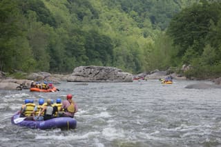 Rafting group paddling through whitewater with Blackwater Outdoor Adventures