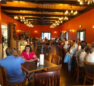 Guests dining beneath timber beams inside Canaan Valley BBQ