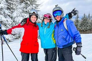 Skiers riding a chairlift above snowy trails at Canaan Valley Resort