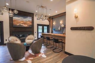 Lounge with a fireplace and exposed timber framing at Canaan Valley Spa & Wellness Center