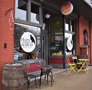 Happy & More Bakery & Cafe storefront with outdoor tables in Thomas