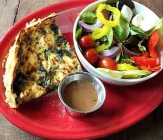 Savory entree and side salad served at Milo's Restaurant & Bar