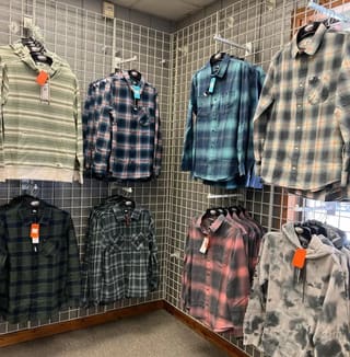 Flannel shirts and winter apparel displayed inside The Ski Barn