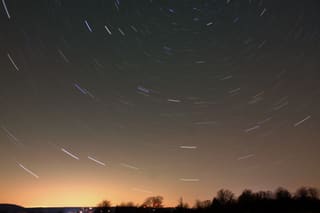 Star trails curving across the night sky above Canaan Valley National Wildlife Refuge