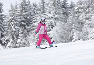 Young skier crossing a snowy slope at Timberline Mountain