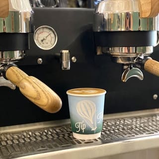 Espresso machine and prepared coffee at Tip Top Coffee Bar