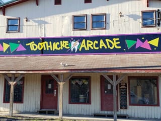 Colorful Toothache Arcade storefront on William Avenue in Davis