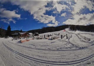 Snow-covered trails and lodge at White Grass Ski Touring Center